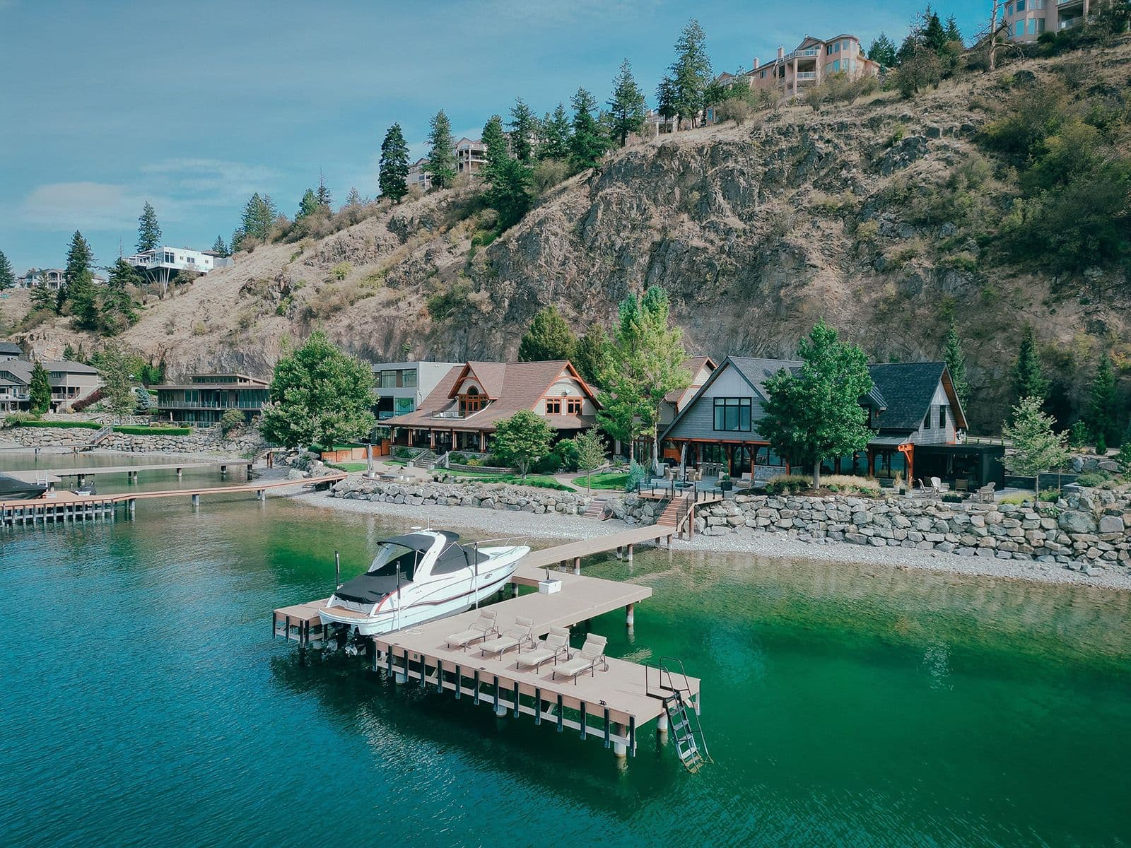 Luxury dock on Okanagan Lake with boat moorage, swim platform, and lounging space, built to complement upscale waterfront homes and maximize lakefront enjoyment.