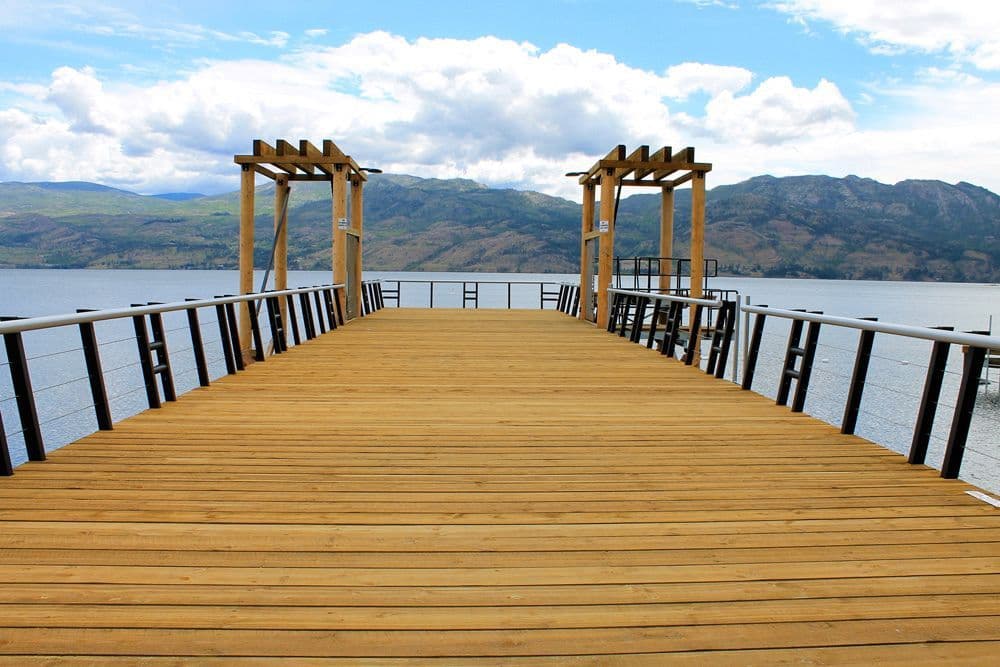 Frontal perspective of the newly constructed public pier at Gellatly Bay in West Kelowna, BC, built with a swimming platform and integrated zipline features.