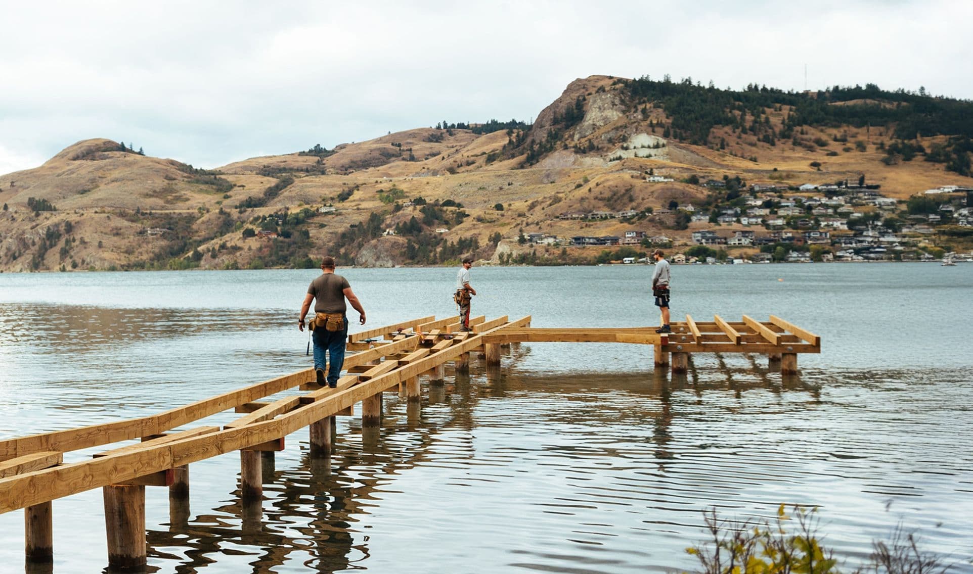 Burton Marine crew building a dock frame on Okanagan Lake, showcasing hands-on marine construction expertise in British Columbia.